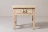 The Baunei nightstand in pale reclaimed elm, front view on a light studio backdrop
