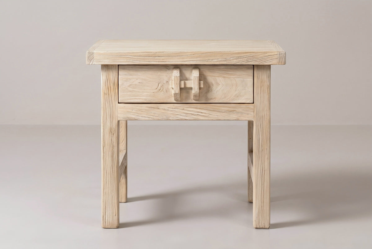 The Baunei nightstand in pale reclaimed elm, front view on a light studio backdrop