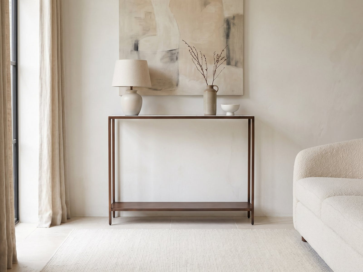 Bellegra White Marble Console Table against a plaster wall under an abstract canvas in a bright living room