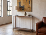 Bellegra White Marble Console Table against a plaster wall in an industrial loft
