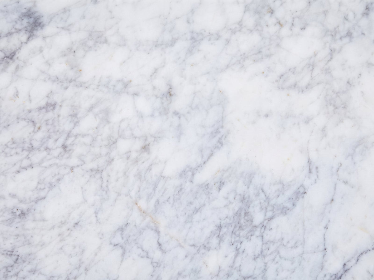 Close-up of the Bellegra White Marble Console Table: the grey-lavender veining of the white marble top