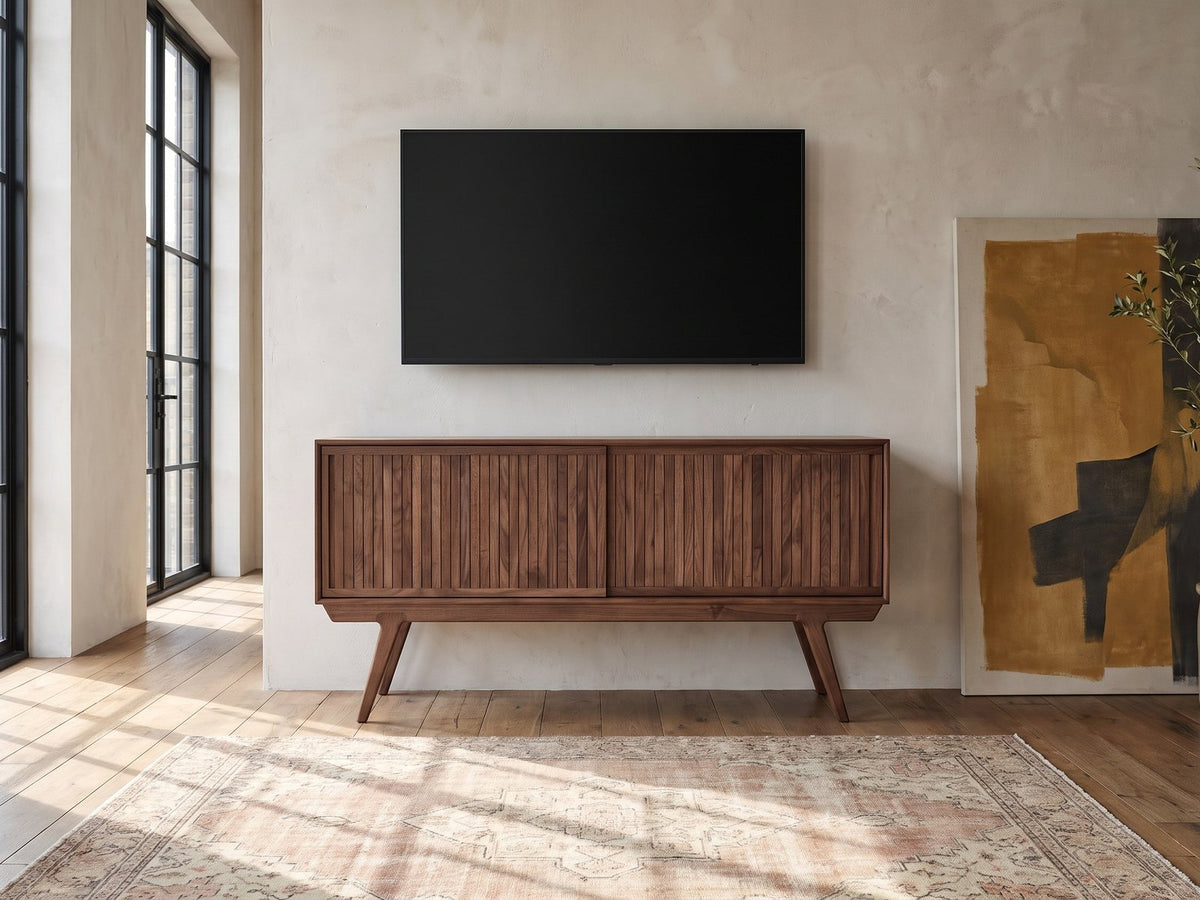 Belluno Solid Walnut Media Cabinet under a wall-mounted screen in an industrial loft