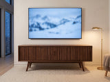 Belluno Solid Walnut Media Cabinet under a screen showing a snowy landscape on a winter evening