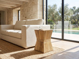 Belmonte Mango Wood Hourglass Side Table beside a linen sofa in a poolside villa