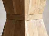 Close-up of the Belmonte Mango Wood Hourglass Side Table: the square waist band between the two tapered halves