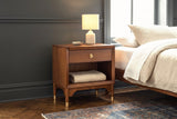 Berchidda nightstand against charcoal wall panelling in a New York apartment bedroom, a herringbone floor and a faded blue rug