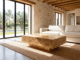 Biella 43-Inch Rectangular Burl Wood Veneer Coffee Table seen from the side, on a jute rug in front of a linen sofa in a poolside villa