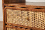 The upper drawer of the Bitti nightstand: a panel of woven cane in a rounded chestnut frame with a small brass knob, and the open cubby above