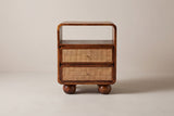 The Bitti nightstand in chestnut mango, front view on a light studio backdrop
