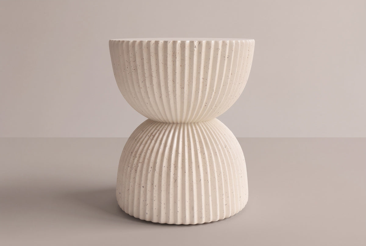 The Bivona side table from the side: a ribbed upper bowl under the round top, a narrow waist at mid-height and a ribbed lower bowl down to the base