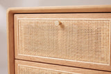 The top drawer of the Bono nightstand: woven cane in a slim oak frame with a small round gold knob at the top centre