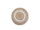 Bordighera Braided Jute and Cotton Round Pouf seen from above on white: the spiral-braided jute top with its off-white cotton rings