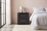 Bosa charcoal oak nightstand against a blush pink plaster wall in a Palm Springs bedroom with a polished concrete floor and a steel-framed window