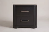 The Bosa nightstand in charcoal oak, front view on a light studio backdrop: two drawers with bar pulls, reeded rounded corners and shaped feet