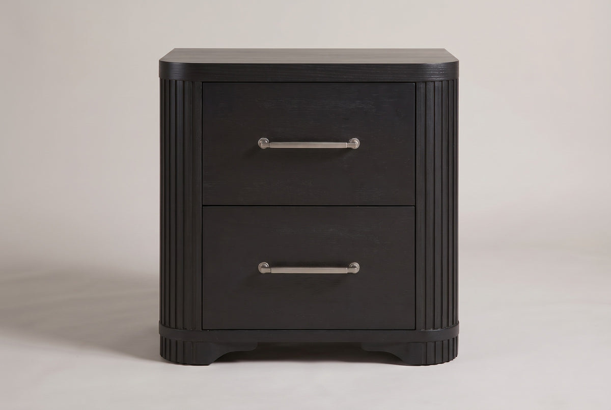 The Bosa nightstand in charcoal oak, front view on a light studio backdrop: two drawers with bar pulls, reeded rounded corners and shaped feet