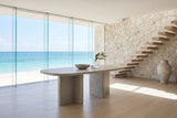 Bova 82-Inch Oval Grey Oak Veneer Dining Table in an oceanfront glass house
