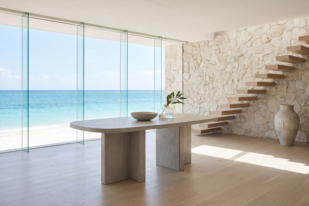 Bova 82-Inch Oval Grey Oak Veneer Dining Table in an oceanfront glass house