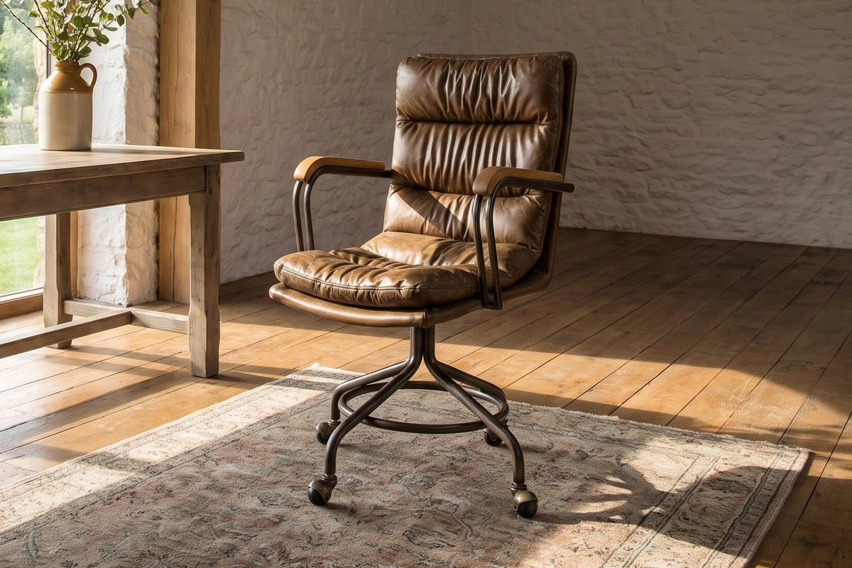 Bovalino Pillowed Top-Grain Leather Swivel Desk Chair with Wood Arms in a converted barn