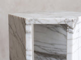 Close-up of the Bovino White Marble Hexagon Side Table: an open window between the marble walls