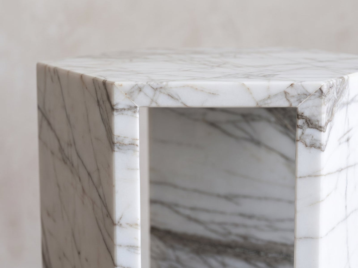 Close-up of the Bovino White Marble Hexagon Side Table: an open window between the marble walls