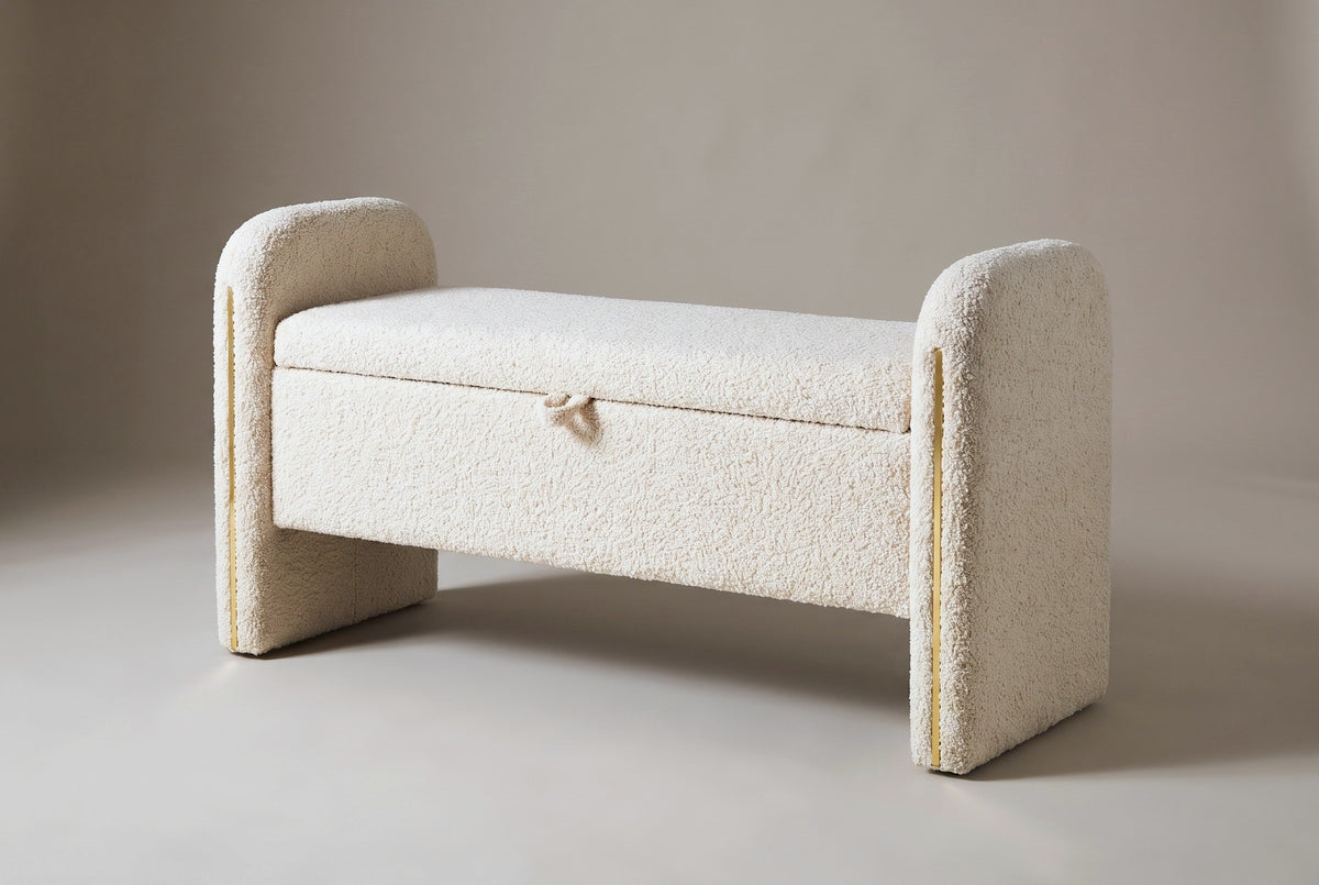 The Bracciano storage bench in cream teddy fabric, three-quarter view on a light studio backdrop, lid closed