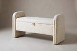 The Bracciano storage bench in cream teddy fabric, three-quarter view on a light studio backdrop, lid closed