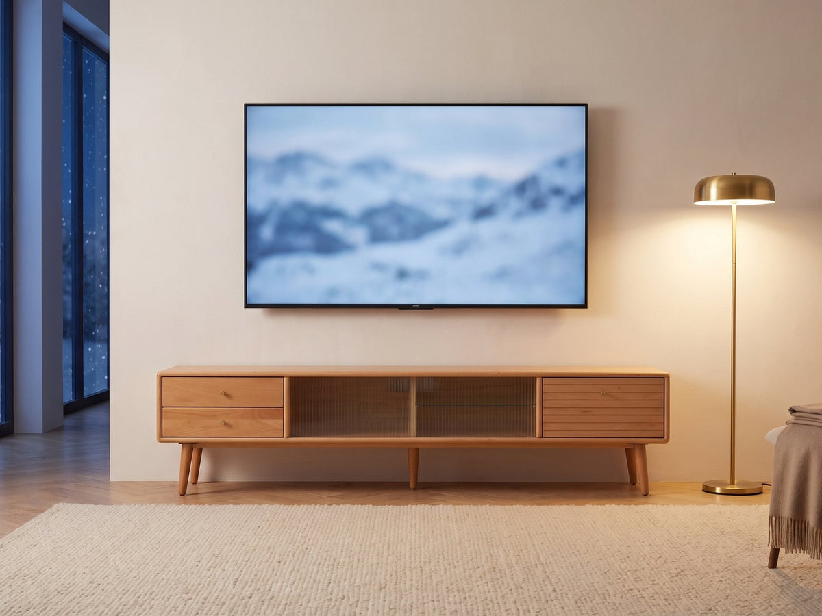 Bressanone Solid Beech Media Console under a screen showing a snowy landscape on a winter evening