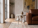 Brienza Reclaimed Pine Sphere-Leg Side Table beside a leather sofa in an industrial loft