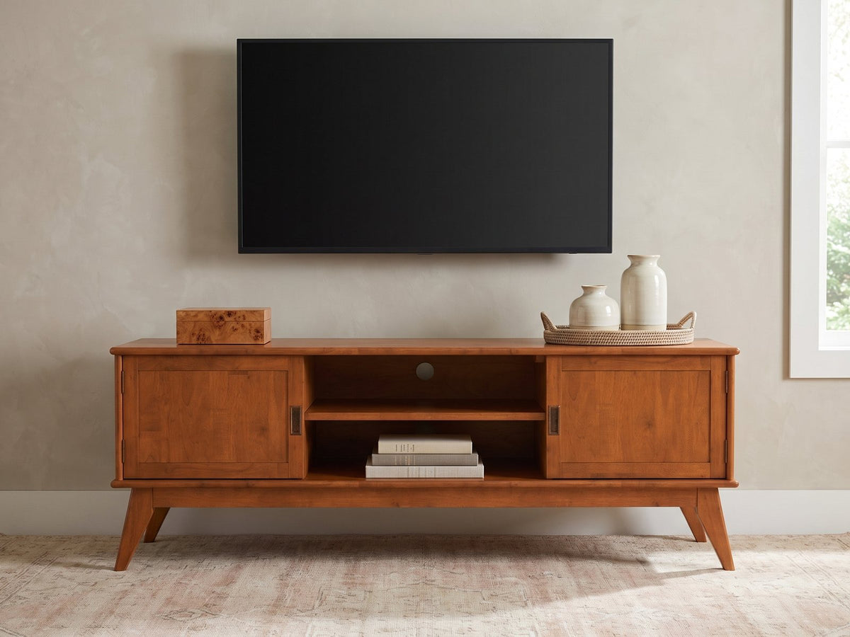Brisighella Mid-Century Media Console styled with a box, a tray of vases and books under a wall-mounted screen