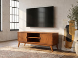 Brisighella Mid-Century Media Console seen from the side, under a wall-mounted screen in an industrial loft