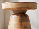 Close-up of the Bronte Solid Mango Pedestal Side Table: the thick mango top over the neck and the block-built cone