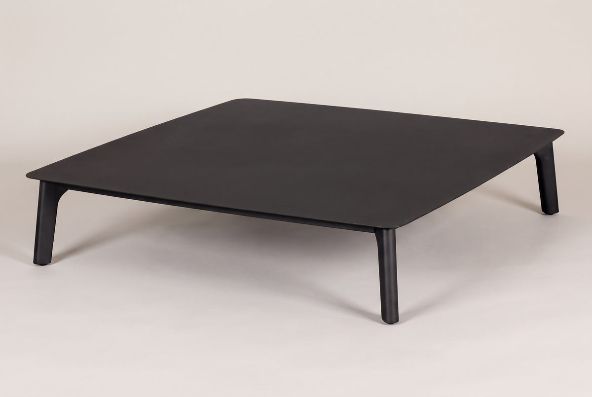 The Brucoli square outdoor coffee table in matte black aluminum, three-quarter view on a light studio backdrop