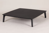 The Brucoli square outdoor coffee table in matte black aluminum, three-quarter view on a light studio backdrop
