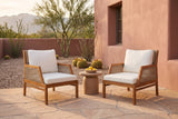 Two Buccheri club chairs on a sandstone flagstone patio in Tucson at golden hour, a rose adobe wall, palo verde, ocotillo and barrel cacti behind (side table not included)