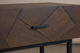 The drawer front of the Budoni nightstand: angled oak pieces with fine dark grooves and one short black bar pull in the middle
