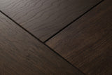 Close-up of the Budoni nightstand: smoked brown oak veneer in angled pieces separated by fine dark grooves