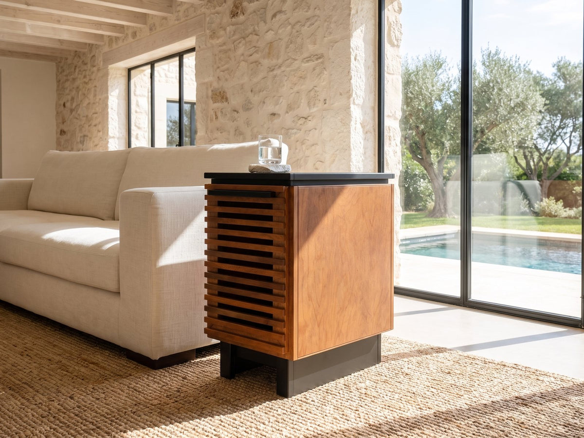 Buonvicino Bourbon and Black Slatted Side Table beside a linen sofa in a poolside villa