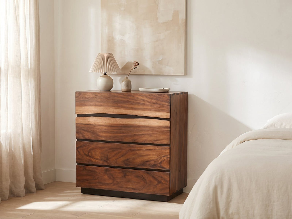 Burano 40-Inch Smokey Walnut 4-Drawer Chest against a plaster wall under an abstract canvas in a bright bedroom