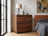 Burano 40-Inch Smokey Walnut 4-Drawer Chest against a plaster wall in an industrial loft bedroom