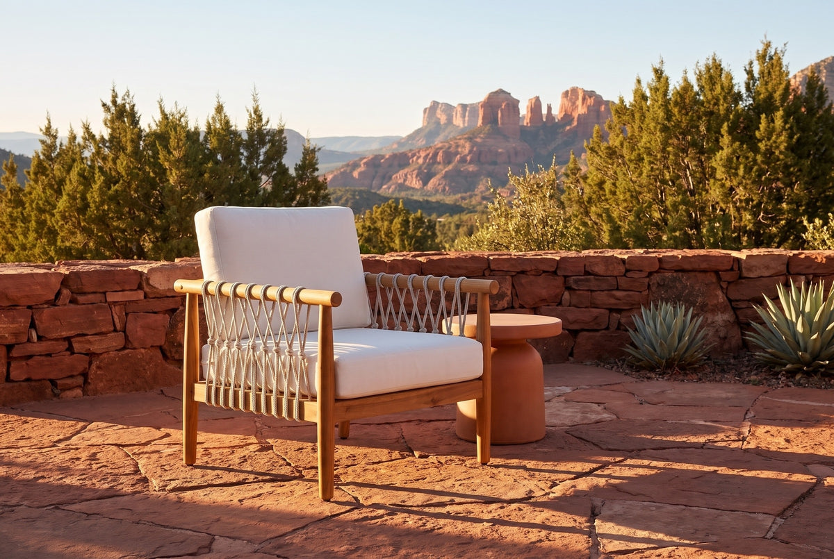 Burgio acacia and rope club armchair on red sandstone flagstones on a Sedona terrace at golden hour, a stacked red-rock wall and the red-rock buttes behind (side table and plants not included)
