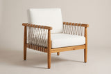 The Burgio outdoor club armchair in teak-finish acacia with beige rope lacing and cream seat and back cushions, three-quarter view on a light studio backdrop