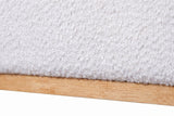 Close-up of the Bussi bed where the white boucle base meets the light rubberwood plinth
