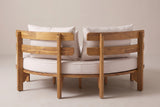 The Butera daybed from behind: two separate curved backrest sections with two slats each, square posts down to the ground