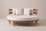 The Butera round daybed seen from the front: the round cushion, four pillows and both curved backrest sections