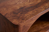 Close-up of the chestnut mango wood on the Cabras nightstand: swirling grain and knots on a warm reddish brown