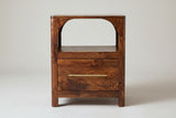 The Cabras nightstand in chestnut mango, front view on a light studio backdrop