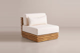 One Calamosche club chair on its own: the layered acacia base, the slatted back panel and the ivory seat cushion, back cushion and lumbar pillow