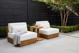 Calamosche acacia chat set in a Dallas courtyard, a charcoal horizontal board fence, a pale concrete floor and a crape myrtle behind