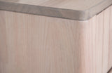 Close-up of the Calangianus nightstand: pale whitewashed hardwood with fine grain and the darker grey-washed rounded edge of the top