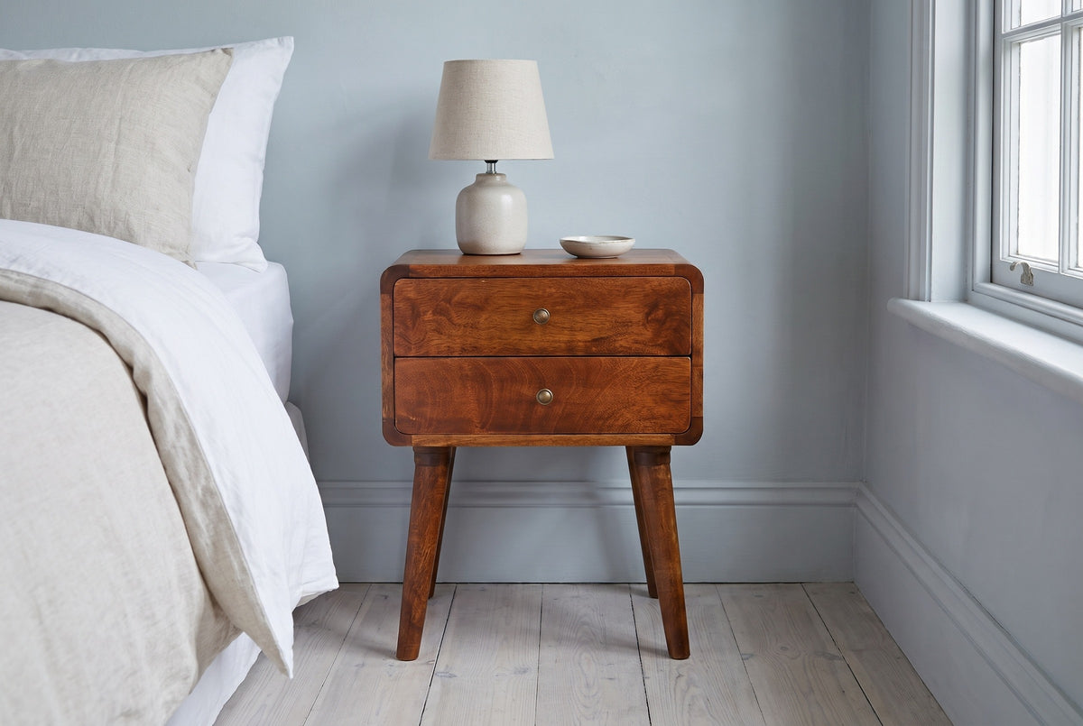 Calasetta chestnut mango nightstand with a ceramic lamp in a Philadelphia bedroom with a powder blue-grey wall and pale oak floors